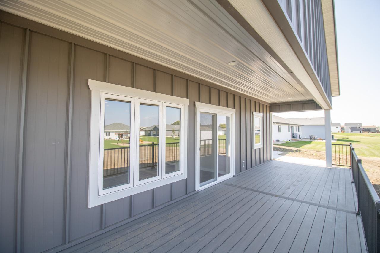 Custom post-frame home with black board-and-batten siding and standing-seam metal roof